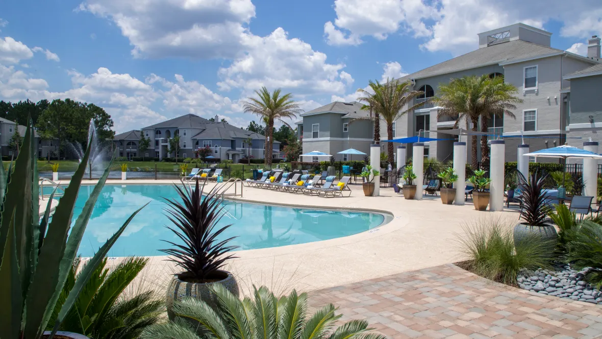 A heated pool by the fountain lake surrounded by a lush tropical landscape creating your perfect vacation zone right at home.  