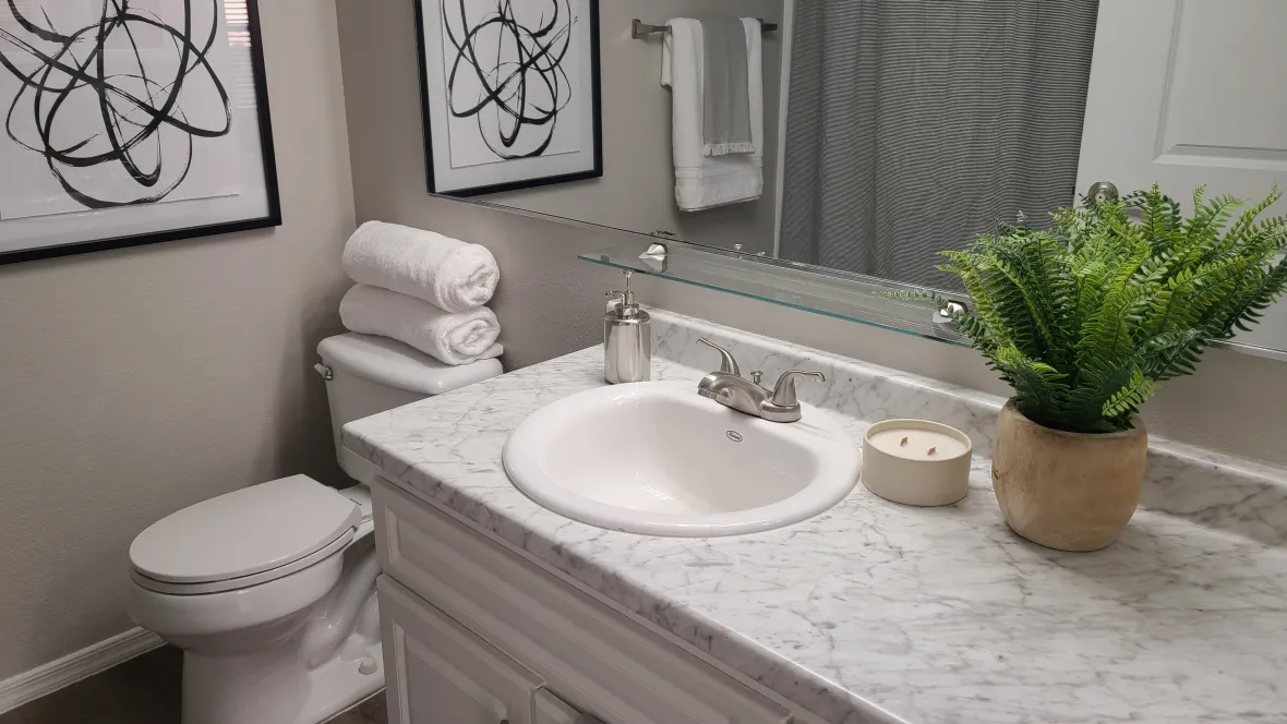 A close up of grey marble-style countertops in a bathroom. 