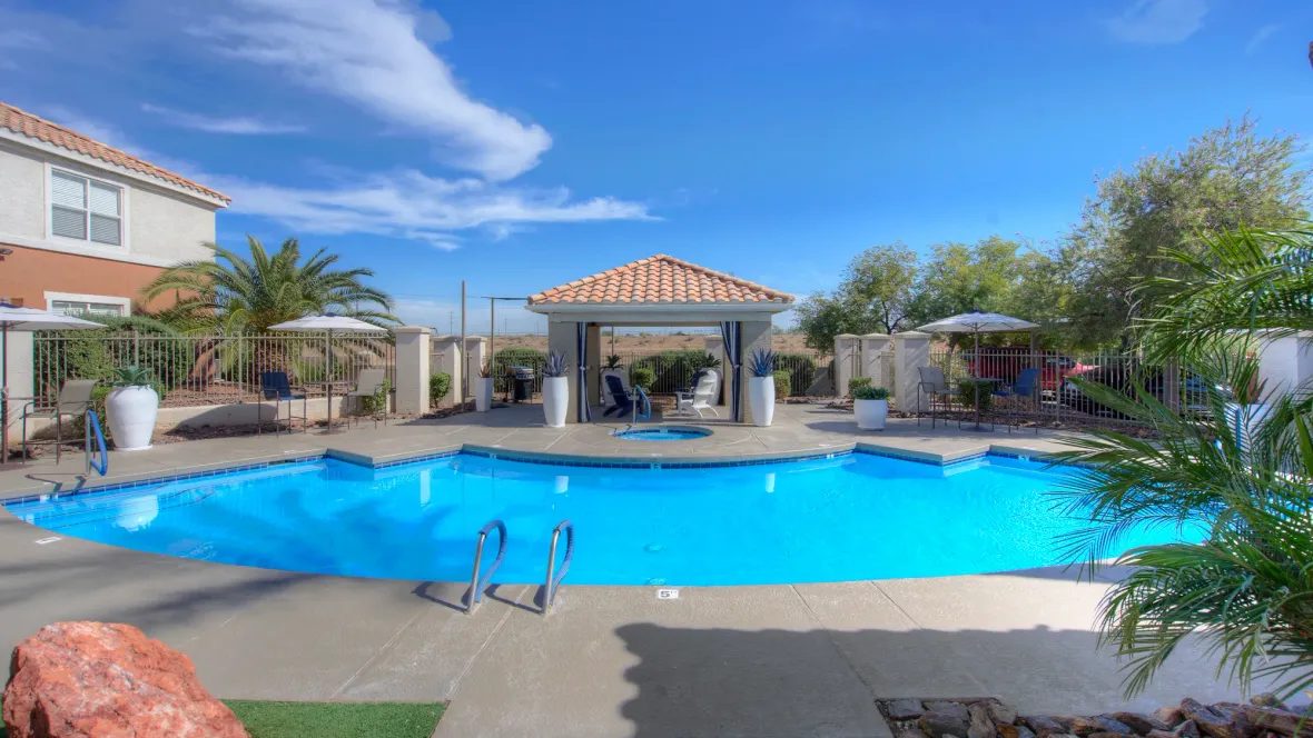 Luxurious, inviting pool with spa and various seating options to enjoy the poolside amenities. 