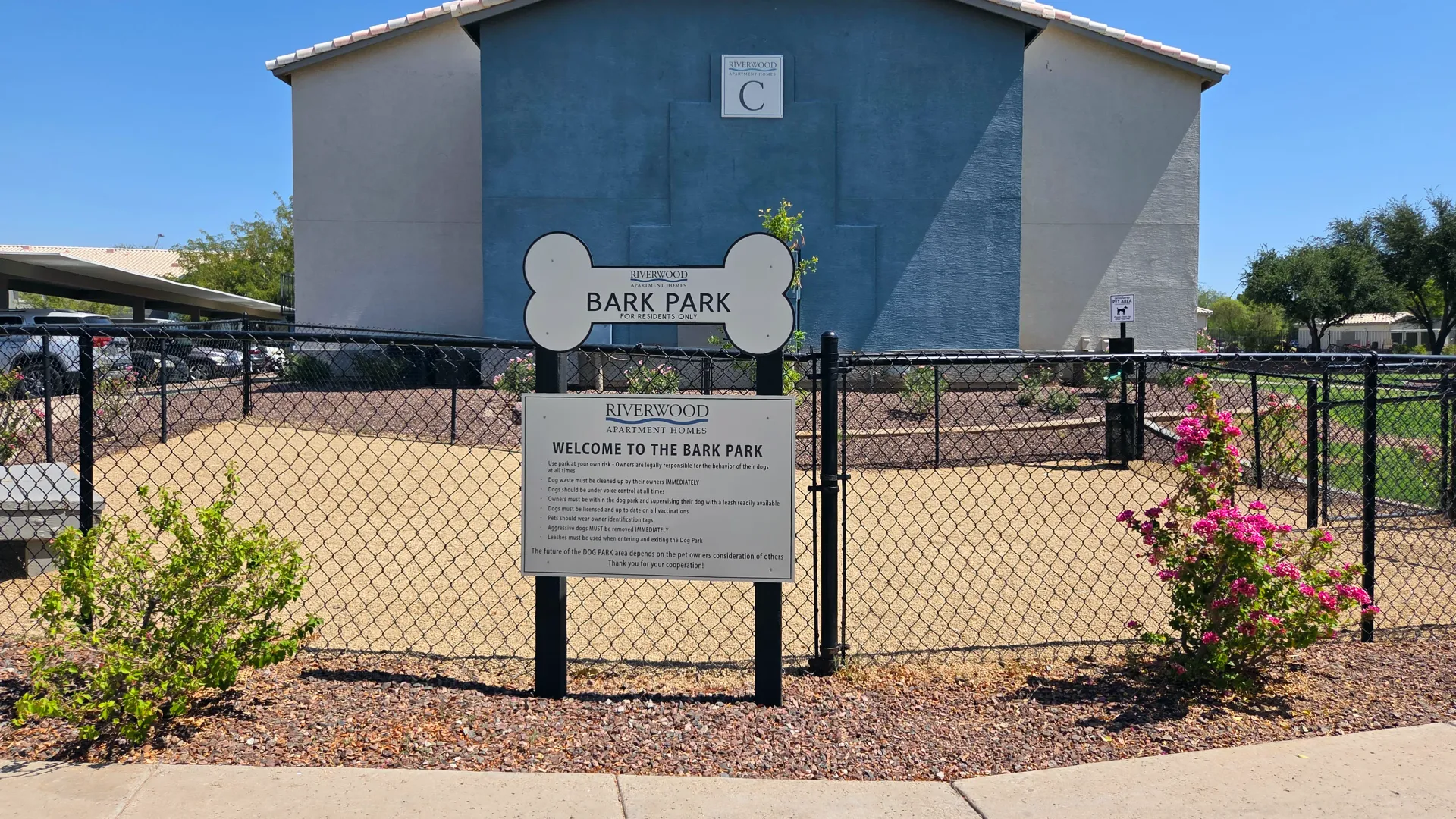 Community bark park at Riverwood Apartments with fenced play area and pet-friendly amenities for residents and their dogs.