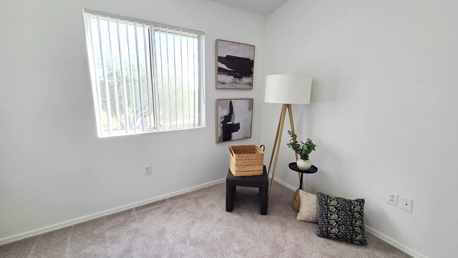 Bedroom with a large window, comfortable carpeting, and bright, airy interior design.
