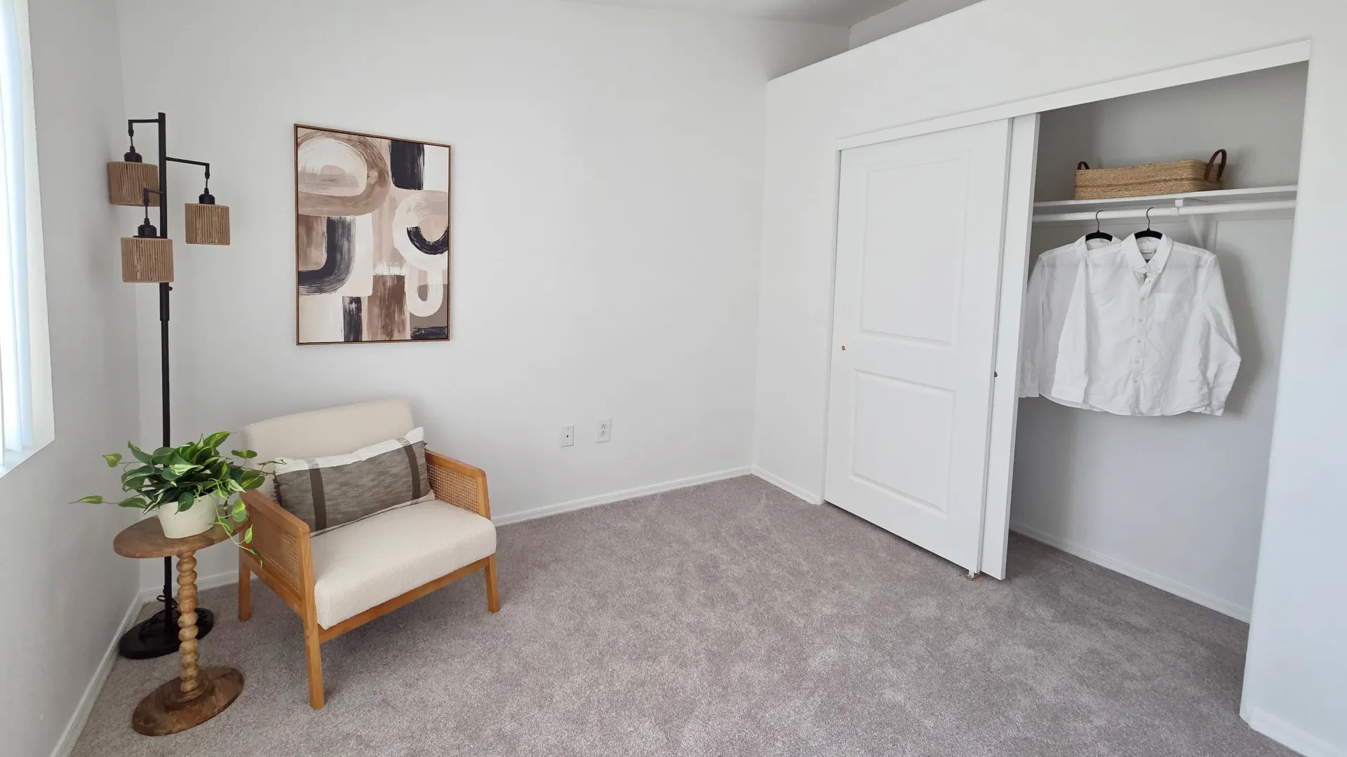 Spacious bedroom with plush carpeting, natural light, and a large closet offering convenient storage space.