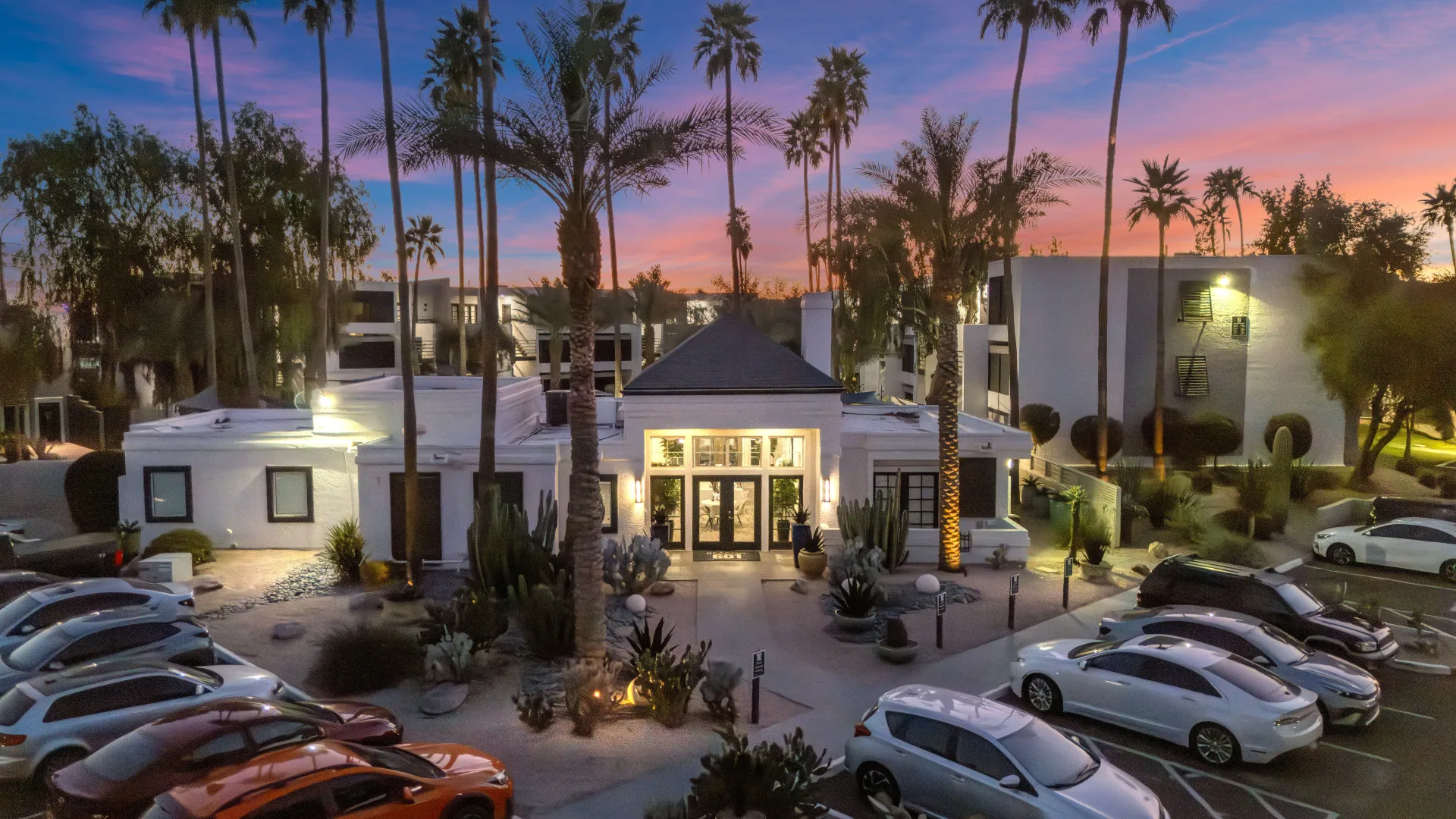 Twilight photo of leasing office with cars in the parking lot