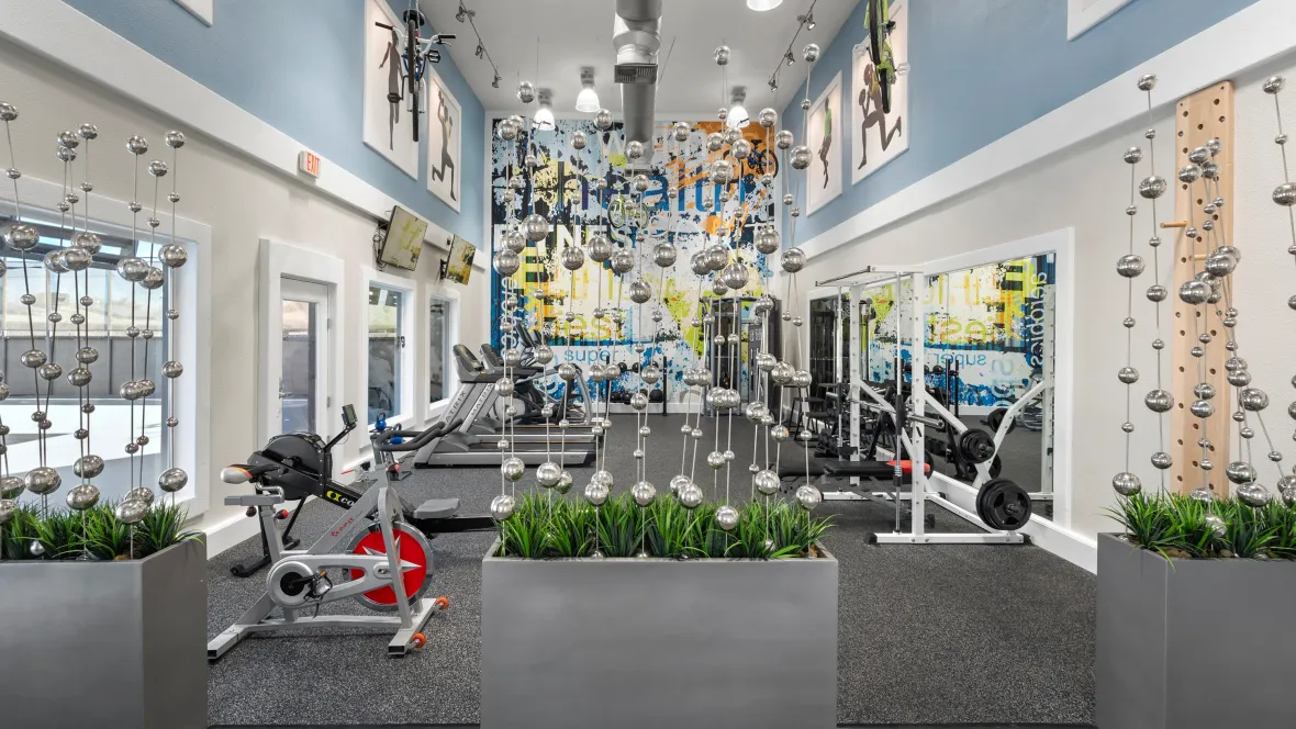 An expansive fitness center full of equipment .