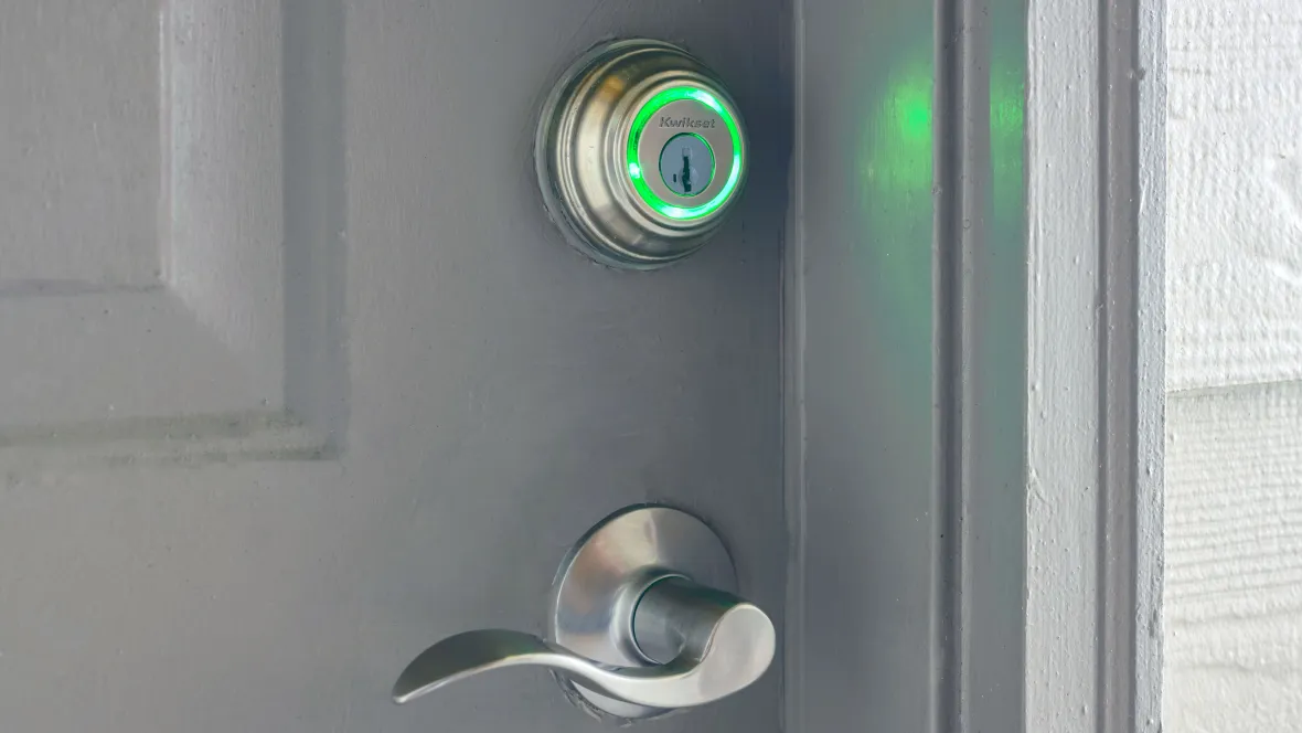 A sleek front door with BeaconTouch smart lock for smartphone keyless entry.