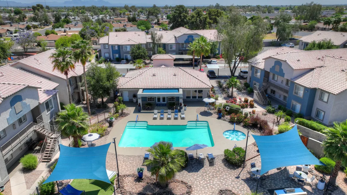 A bird's eye view of our glamorous resort-style pool, the expansive sun deck, bubbling hot tub, and sail-shaded corners, all yours for ultimate relaxation.