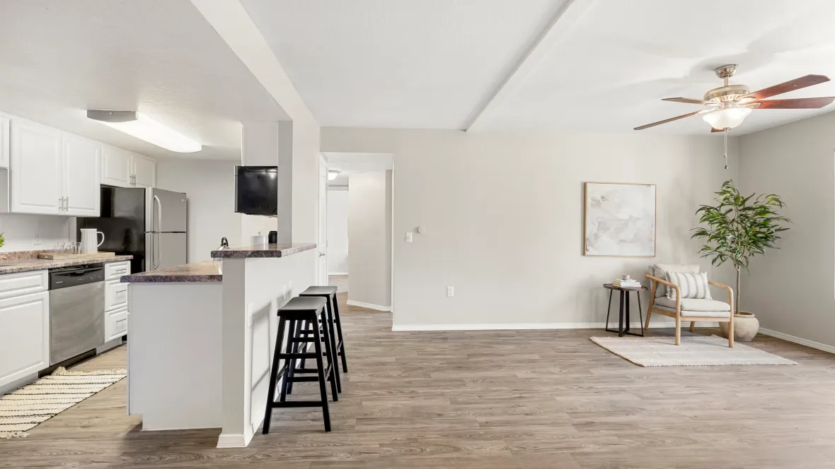 Your versatile breakfast bar adds flair to an open living space. Seamless wood-style flooring ties it all together.