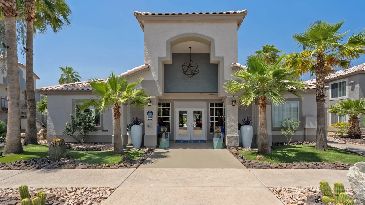 An inviting view of our leasing center, nestled amidst the cacti-laden landscape, radiating a warm welcome.