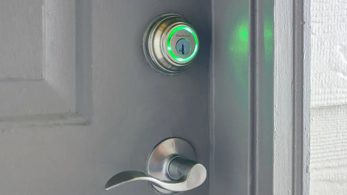 The future of entry with a lighted green Kwikset deadbolt at entry of apartment for easy access.