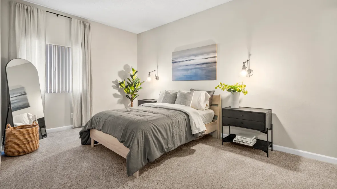 A serene master bedroom adorned with cozy carpeting, ensuring a soft and homely ambiance to start your day.