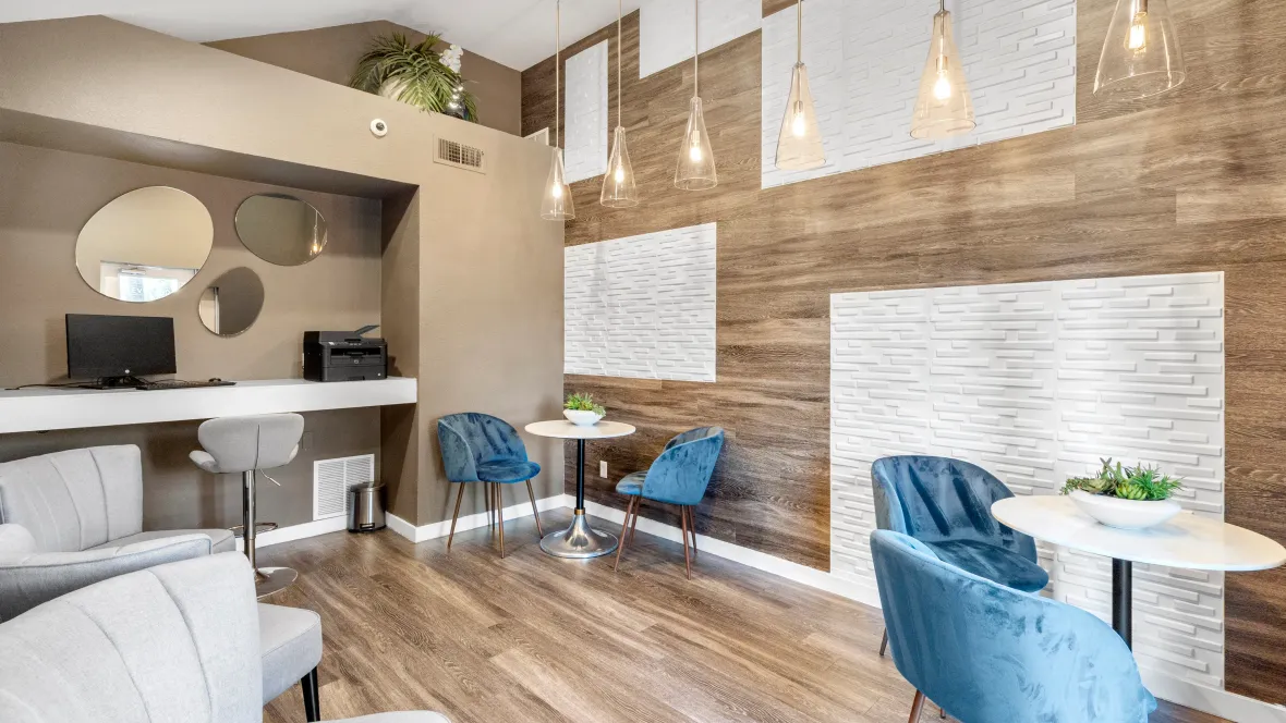 An inspiring work haven with soaring ceilings, captivating lighting pendants, reflective mirrors, and abundant workstations.