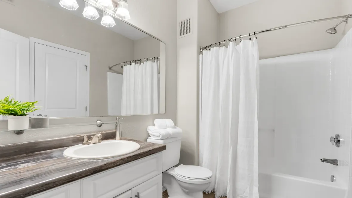 A bathroom paradise with generous countertop space, drawers, cabinets, and a magnificent mirror.