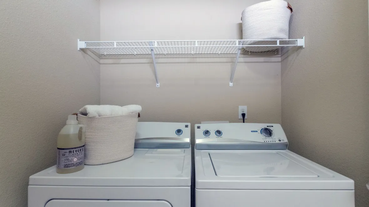 Laundry room featuring a full-size washer and dryer appliance set 