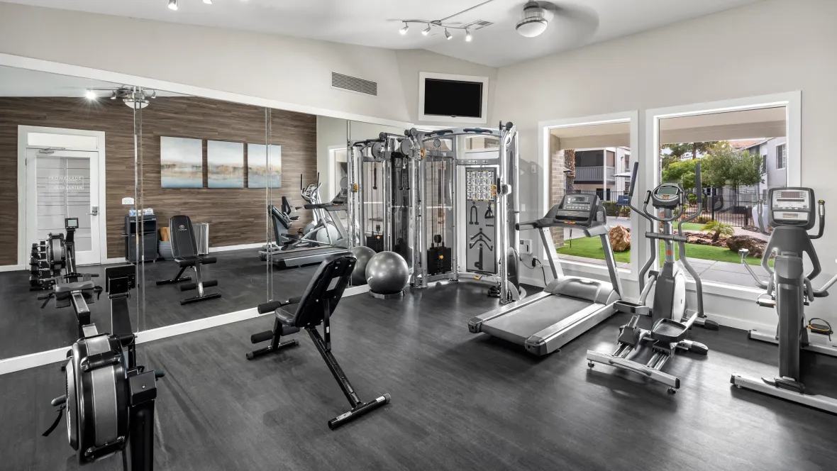 A well-lit fitness center adorned with everything from row machines to ellipticals and a comprehensive weight training center, offering boundless workout possibilities.