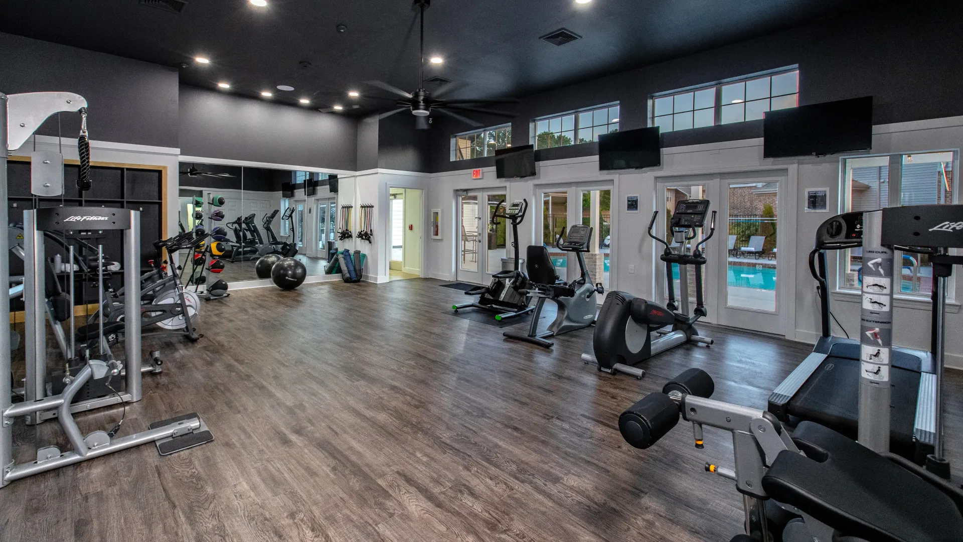Bikes, ellipticals, treadmills, weight training machines, and free weights thoughtfully positioned throughout the spacious fitness center, accommodating a diverse community of residents and fitness goals. 