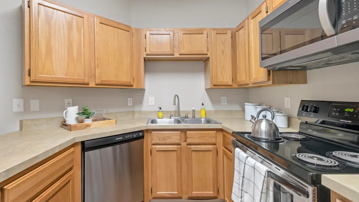 A classic kitchen graced by a breakfast bar and conveniently appointed double sink, a haven for culinary creations.