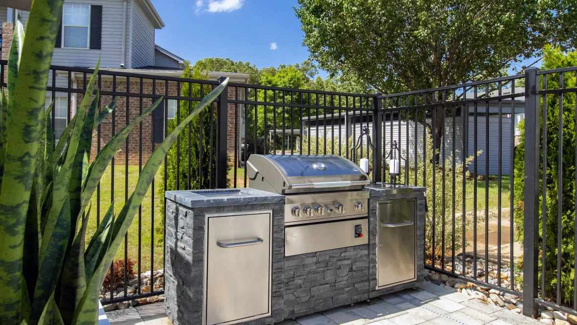 A strategically positioned stainless-steel grill on the pool deck, inviting you to indulge in poolside barbecue delights.