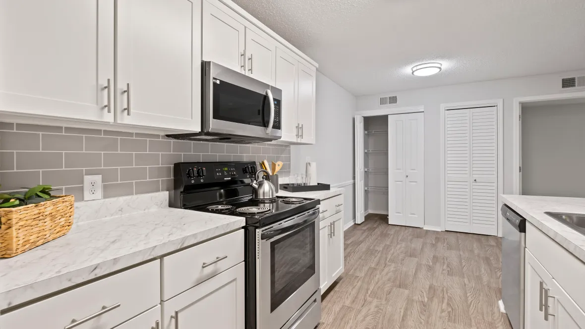 A vibrant, contemporary kitchen with a dining area and a larege conveniently located pantry.