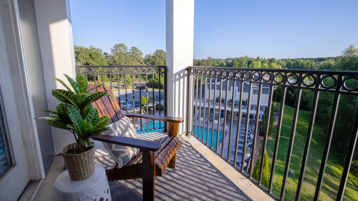 An inviting private patio or balcony with elegant wrought iron railings, a perfect retreat for enjoying the fresh air and creating moments of blissful tranquility.