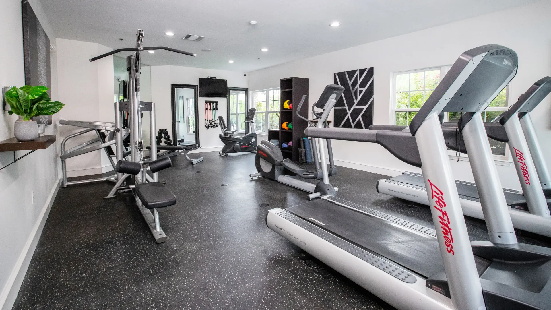 A well-equipped fitness center with modern equipment from weight training machine to ellipticals and treadmills, providing a dedicated space for residents to achieve their fitness goals.