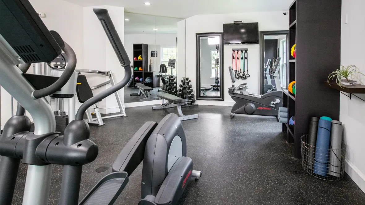 An array of cardio and weight training gear in the resident gym, offering residents a convenient and modern space to elevate their fitness routines.