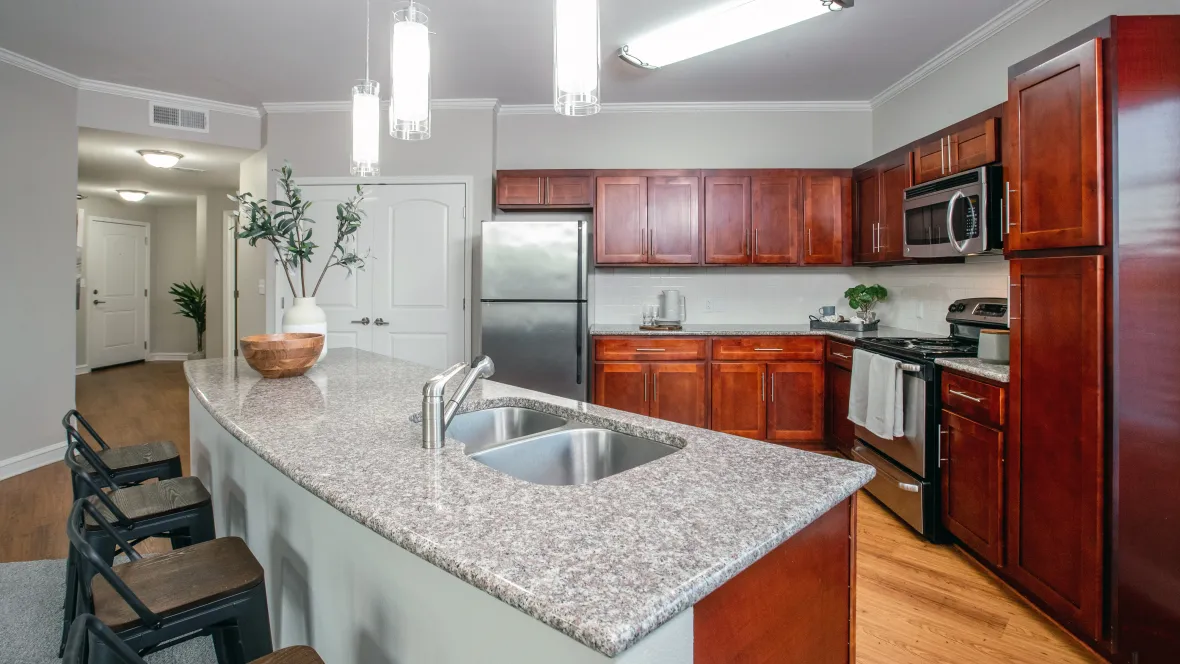 A stylish kitchen featuring a stainless-steel appliance package including refrigerator, dishwasher, stove and microwave.