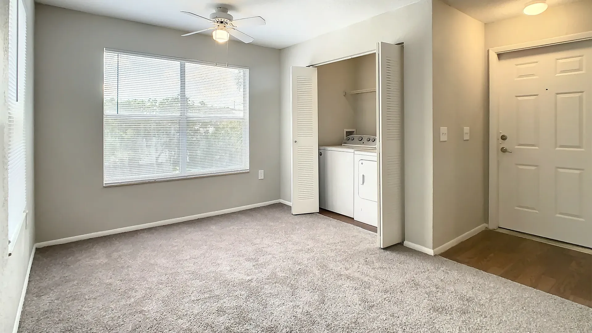 A dining space off the living room, featuring a closet with full size washer and dryer within