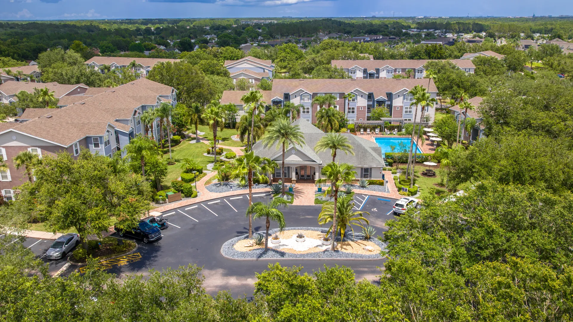 Aerial image showing Ashton Chase leasing office, pool, and beautifully landscaped apartment community.