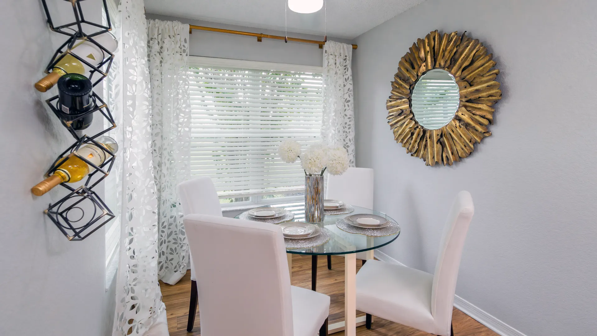Stylish solarium with modern dining setup and large window at Ashton Chase Apartments.