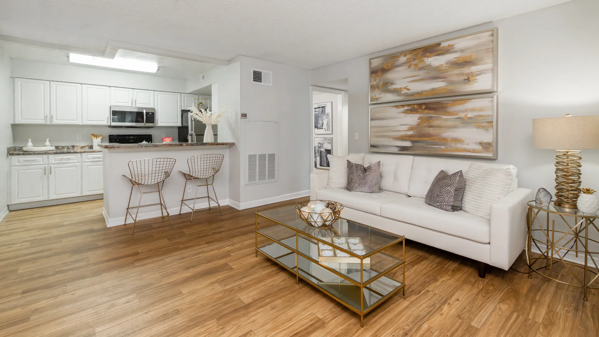 Open-concept layout at Ashton Chase Apartments featuring kitchen with breakfast bar, and a spacious living room.