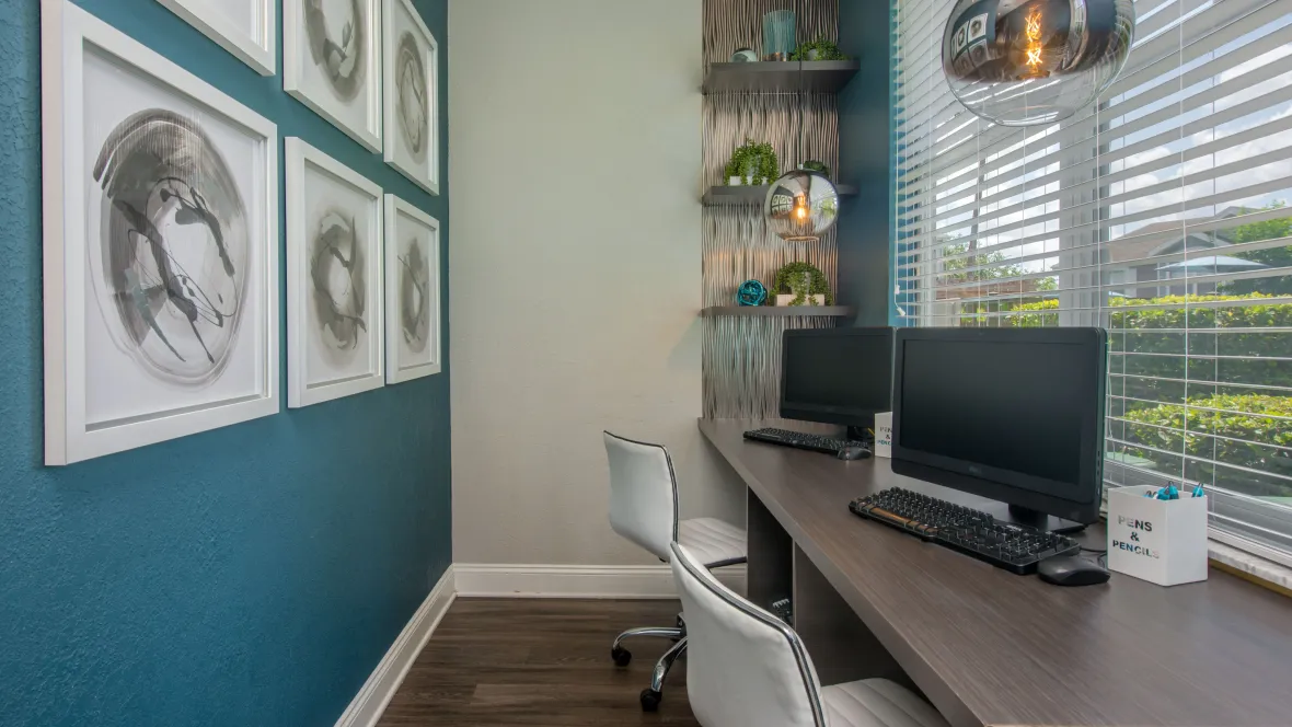 Spacious Business Center desk with two computers and expansive window view.