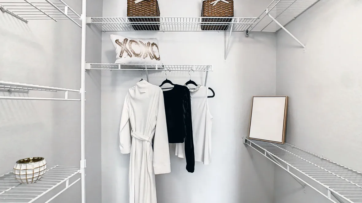 Spacious walk-in closet with built-in organizers.