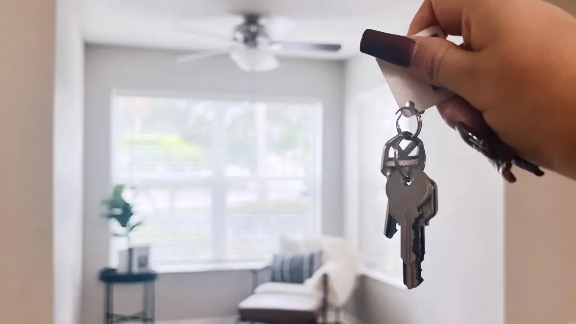 A hand holding up a set of keys within one of our apartment homes.