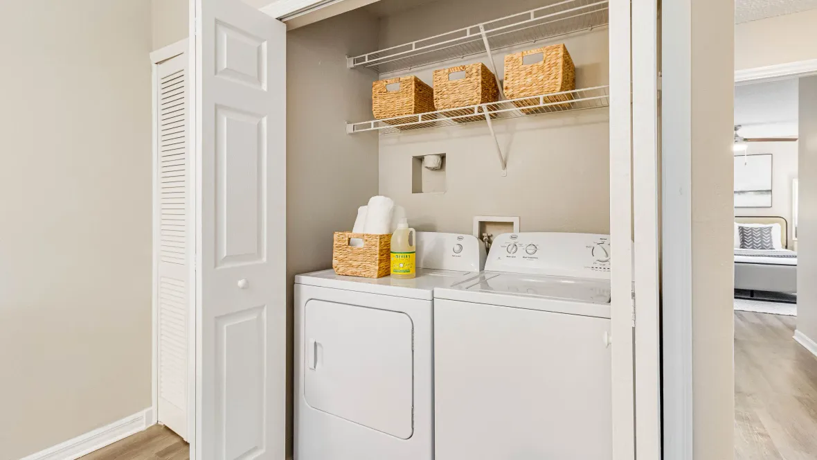 In-home appliance package for your laundry needs, complete with additional storage shelving for convenience.