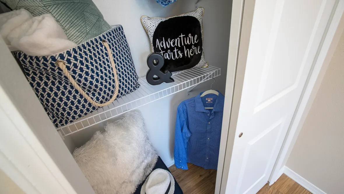 A well-organized closet space with built-in organizers with ample storage for versatile clothes and accessories.