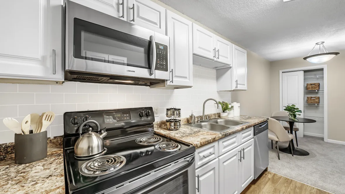 Gleaming stainless-steel appliances, including microwave over the stove and dishwasher, complete this galley kitchen with ample cabinetry in a pleasing layout for effortless cooking.
