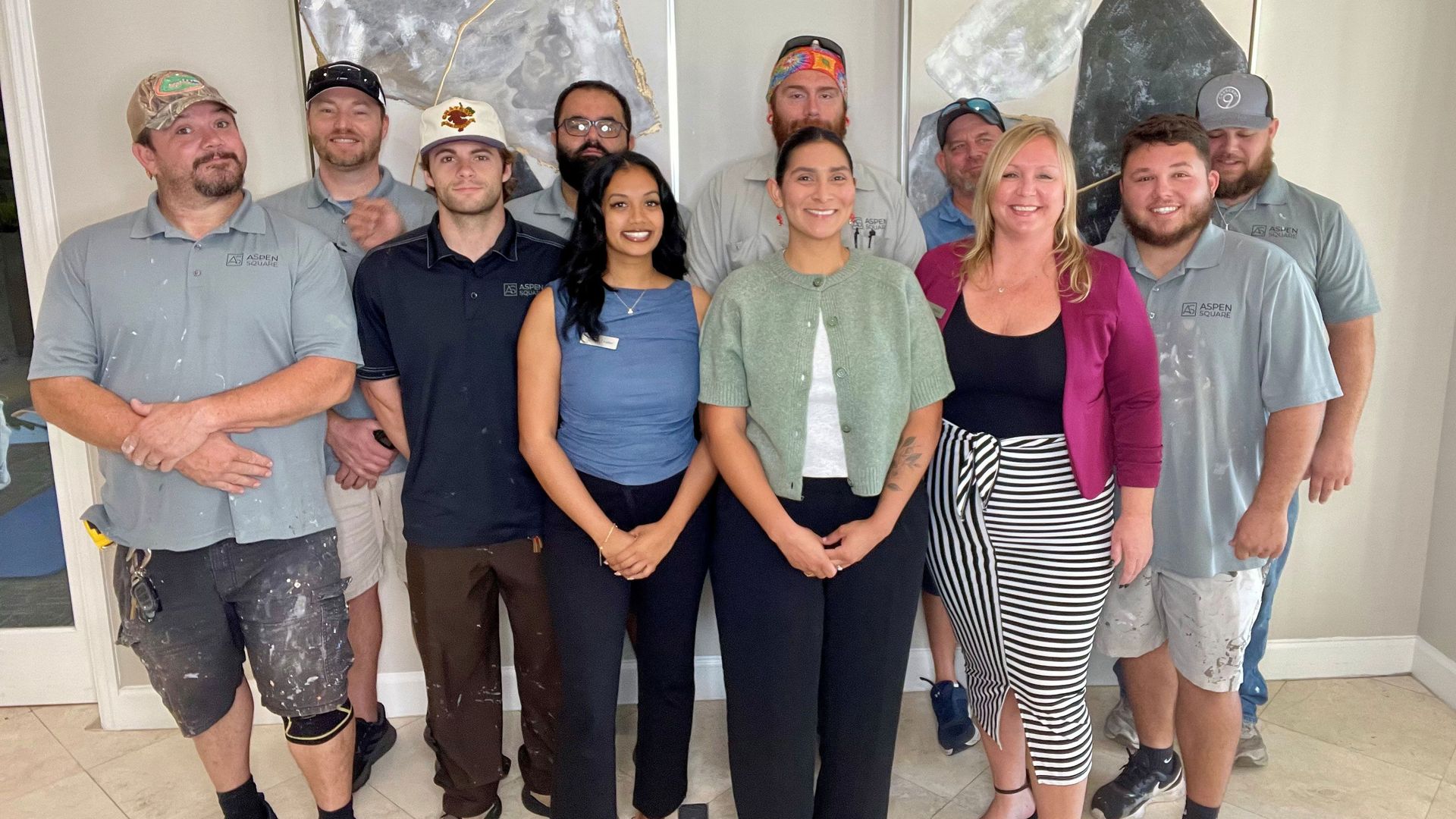 Banyan Bay Apartments team posing together inside the leasing office.