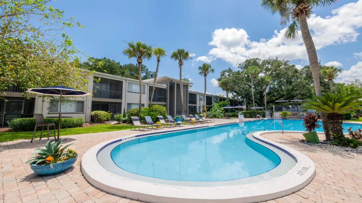 Poolside loungers, bathed in radiant sunlight, line the expansive sundeck, inviting you to dip into the crystal-clear pool's embrace.