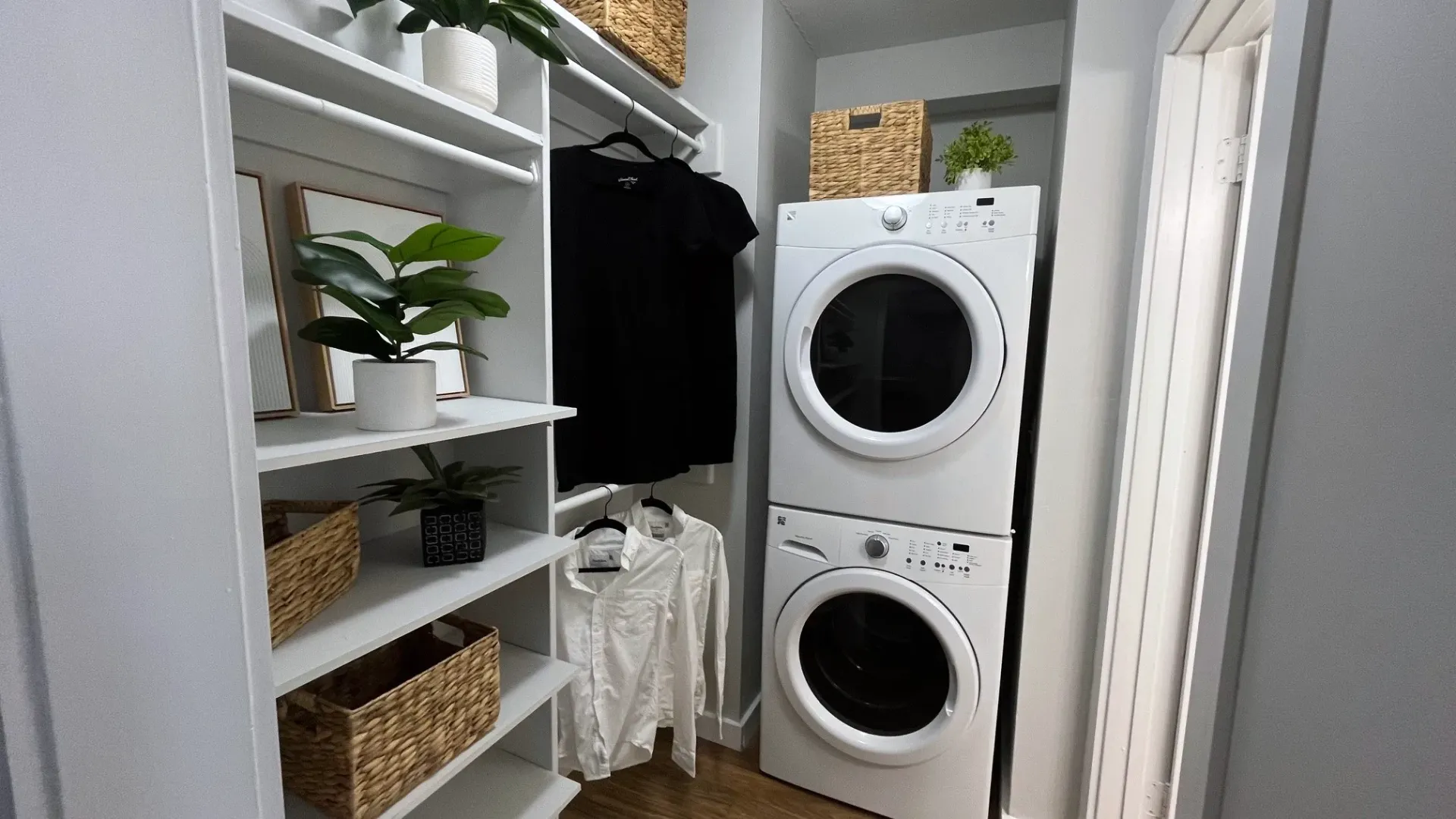 A stackable, front-loading washer and dryer in a walk-in closet