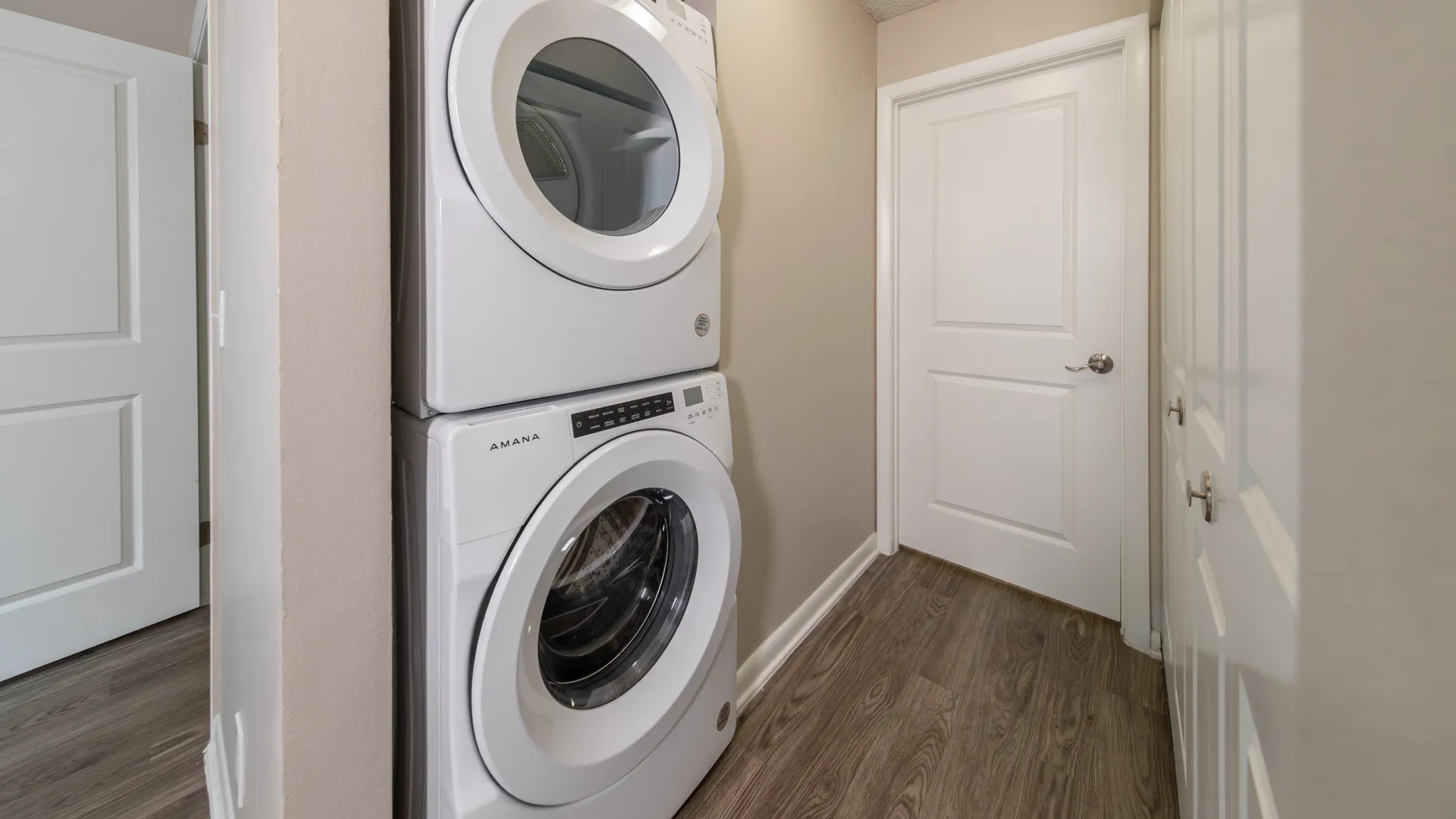 Front-loading, stackable laundry units tucked away in a convenient nook for effortless laundry ease.