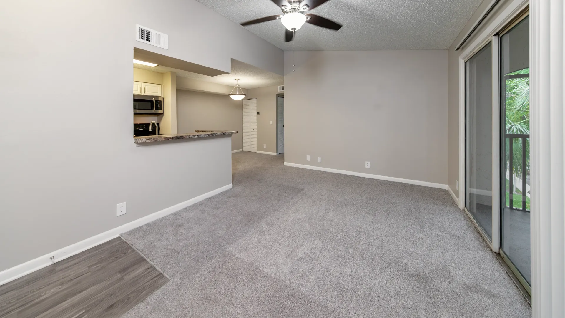 The living room in The Endeavor floor plan seamlessly merges with the kitchen through an open breakfast bar cut-out, revealing a chic kitchen design elements and effortless connectivity across living, dining and kitchen spaces. 