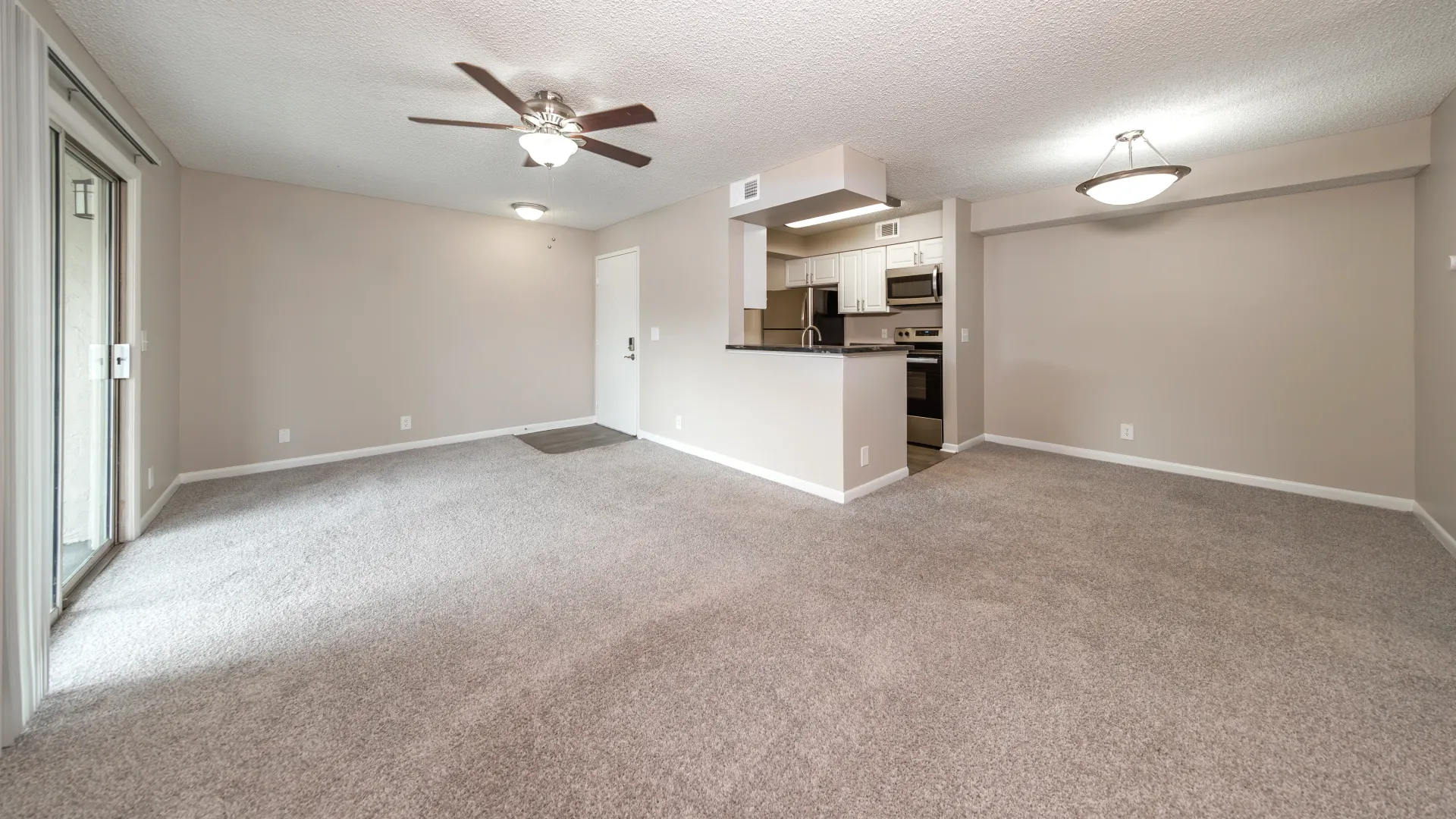 Plush carpets, bright fan, the Pacific Star's living room melds seamlessly with the kitchen, presenting an inviting view across the breakfast bar into the dedicated dining space. 