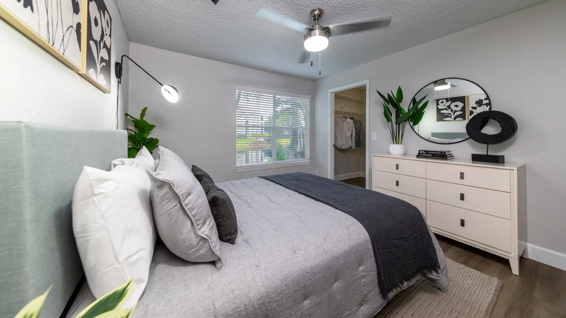 A gorgeous bedroom equipped with a queen-size bedroom suite as well as a look into a large walk-in closet.