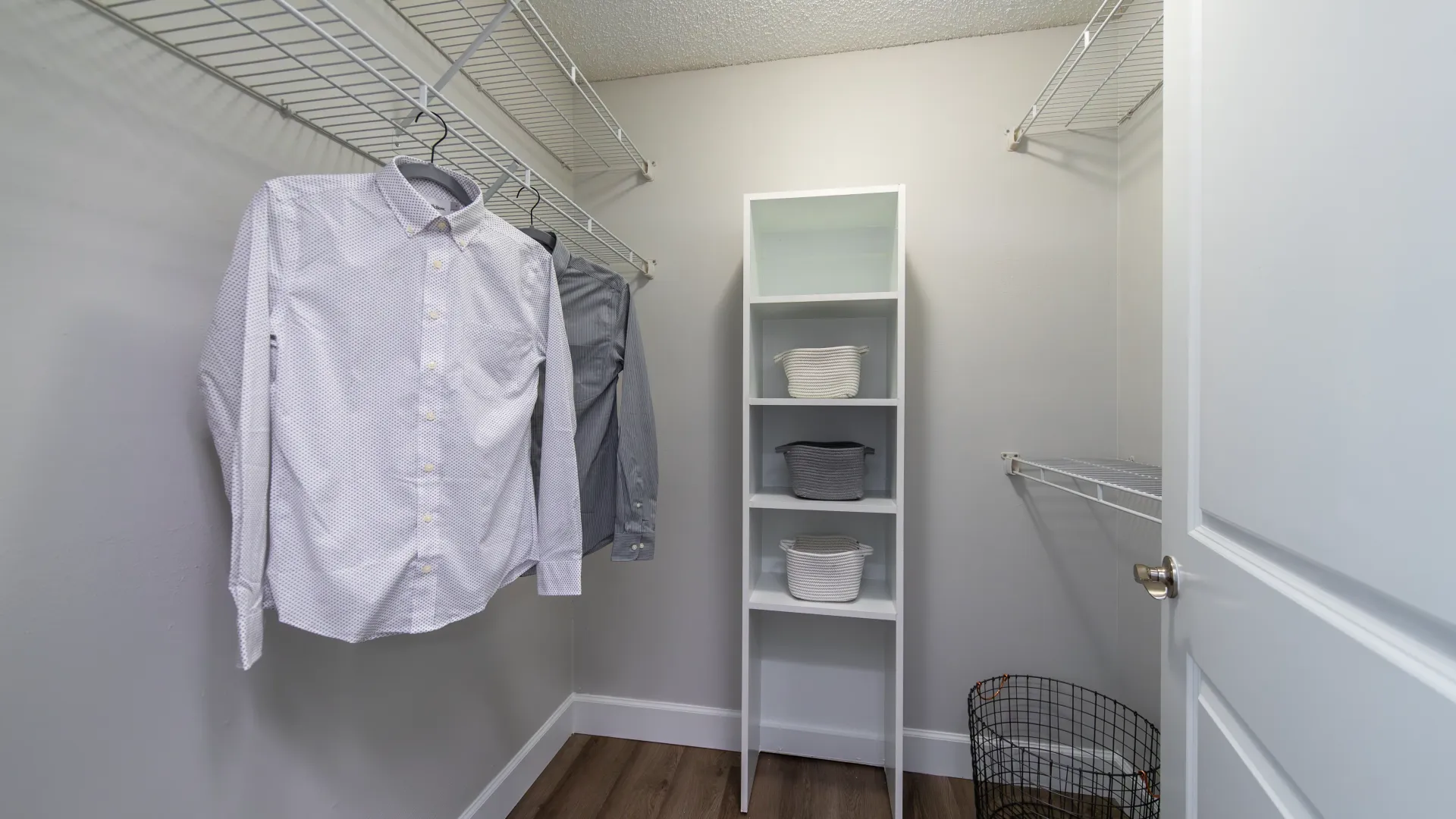 An expansive closet with open wire shelving and a built-in shelf for additional shoe and accessory storage.  