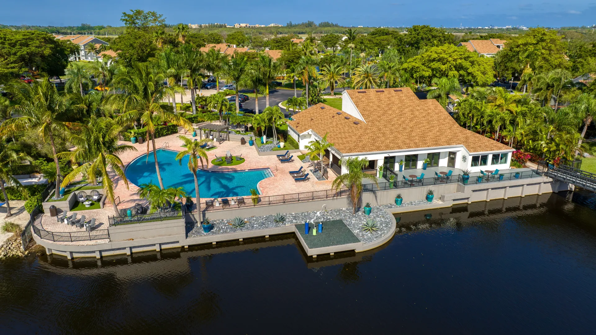 A soaring overhead community view features the exquisite, massive sun deck with a sparkling, half-moon-shaped pool and a huge clubhouse, creating a sun-kissed paradise at Lake Osbourne.