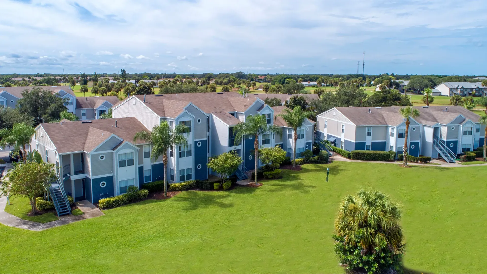 An aerial view of some of the apartment buildings surrounding a lush, green courtyard