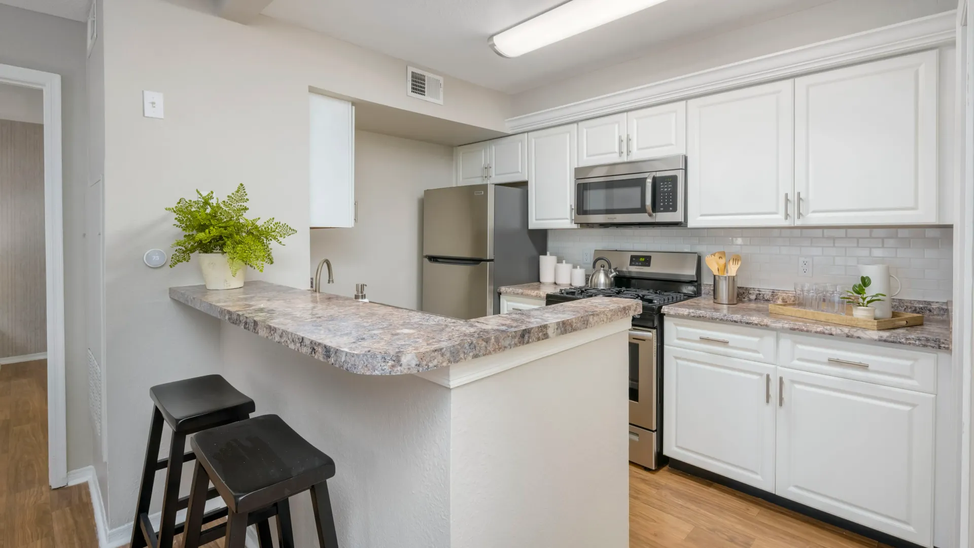 Open kitchen with breakfast bar and ample storage, inviting you to unleash your inner chef.
