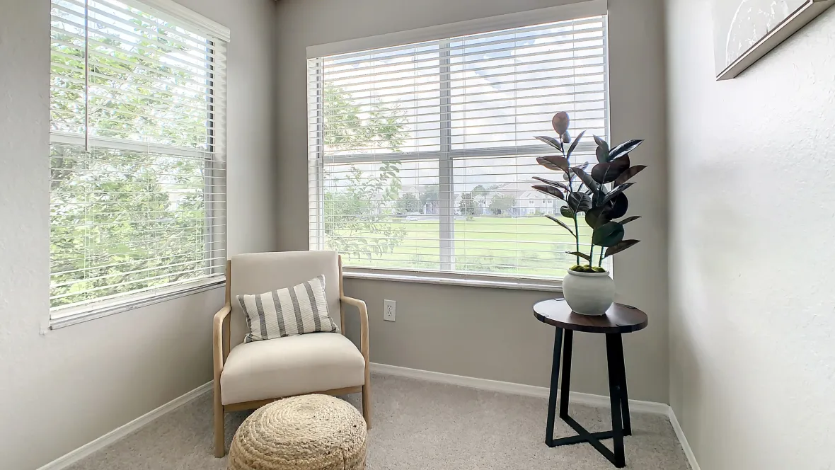 Bright bonus room with two walls of window providing abundant natural lighting complimenting a cheerful space.