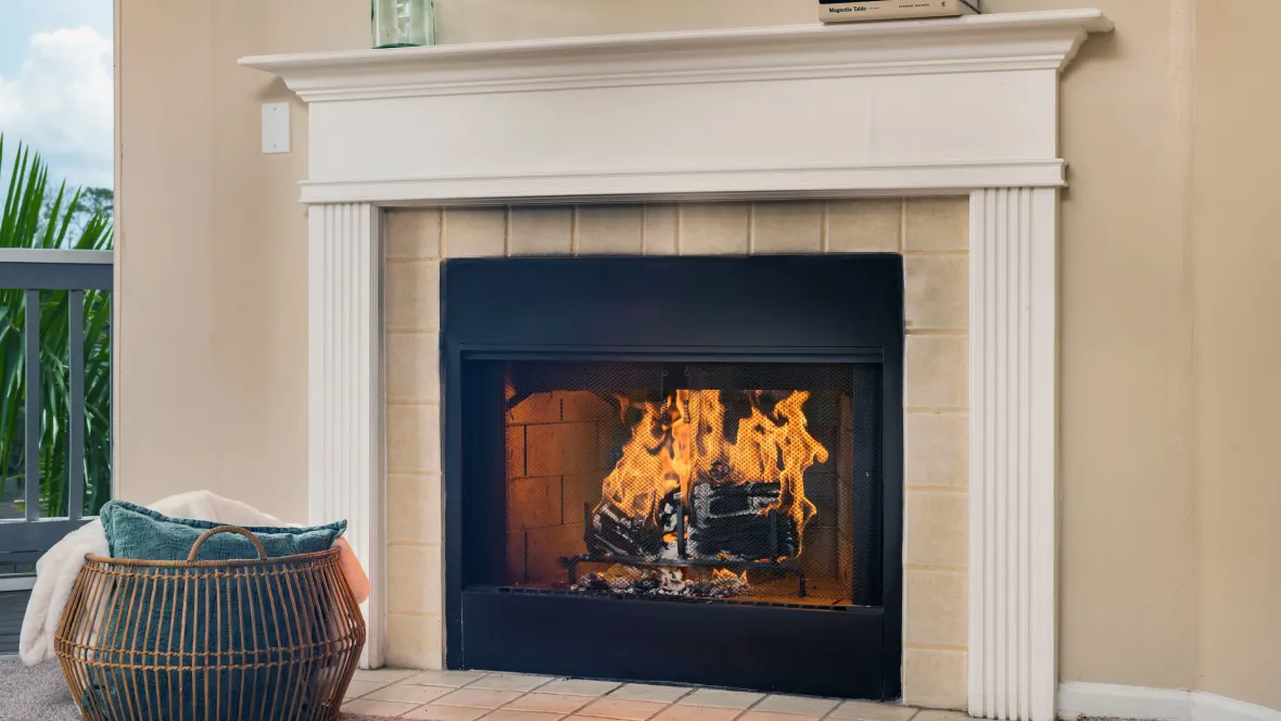 A blazing fireplace with a charming white mantelpiece, exuding warmth and allure, inviting residents to indulge in homey comfort.
