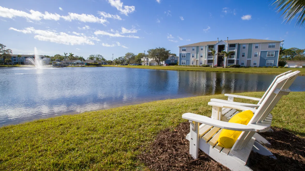 Adirondack chairs placed around the lake provide picturesque views of the brilliantly spouting lake fountain and tranquil waters.